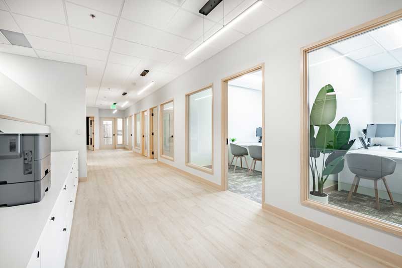 business contruction loans and financing - new modern office hallway with windowed offices.
