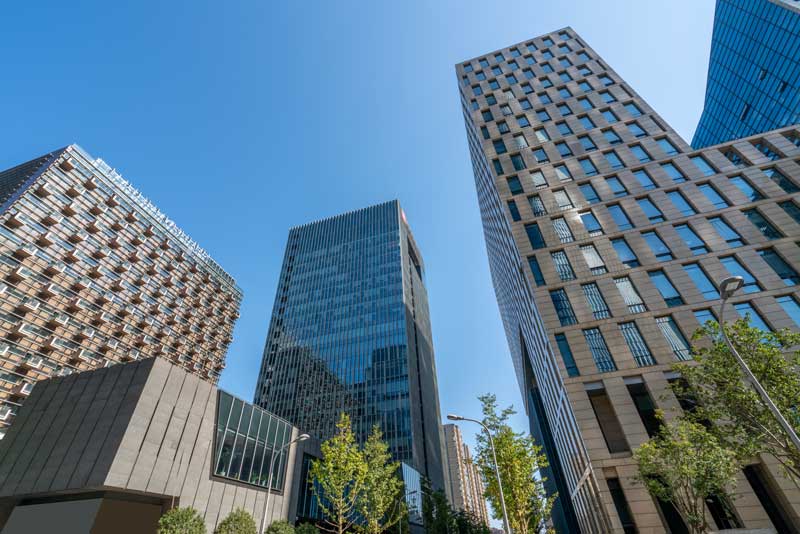 commercial bridge lenders - photo of skyscrapers in the city, photograph shot from the ground looking up.