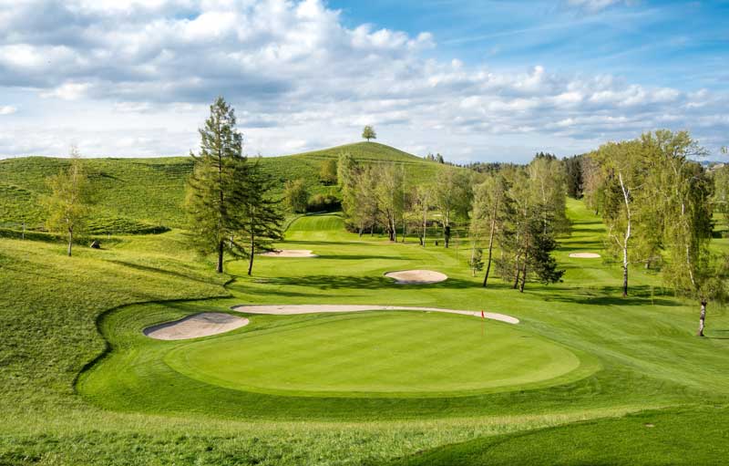 golf course construction loans - Photo description: Beautiful golf and country club course on a warm summer day