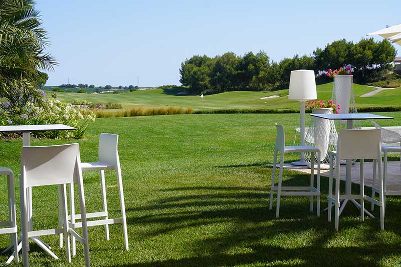 golf course financing - Photo description: tables set up outside a golf course clubhouse overlooking a beautiful golf course.