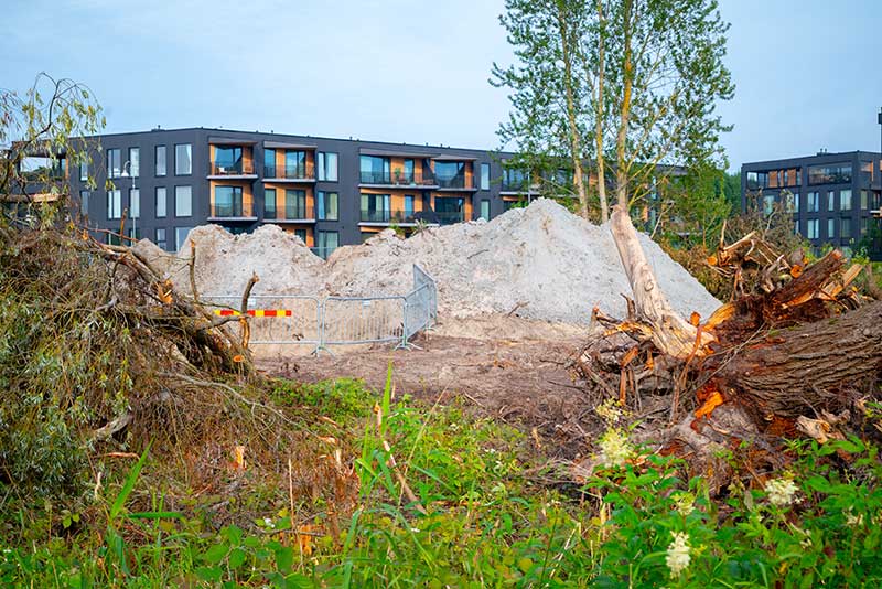 raw and vacant land financing -photo of construction site with a moder building on the background