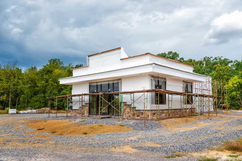 restaurant and bar construction financing - photo is a horizontal shot at an angle of a fast food restaurant under construction.